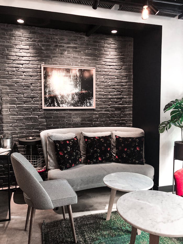 our-story Chic modern lounge with elegant furniture, cozy lighting, and stylish brick wall decor.